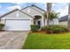 Two-car garage and well-manicured lawn at 4705 Pershoie Ln, Kissimmee, FL 34746