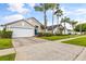 Beautiful house exterior, two-car garage, and lush landscaping at 4705 Pershoie Ln, Kissimmee, FL 34746