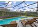 Relaxing screened pool with lounge chairs and inflatable ring at 4705 Pershoie Ln, Kissimmee, FL 34746