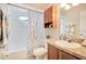 Bathroom with tub, shower, and wood cabinets at 4944 Tangerine Ave # 4944, Winter Park, FL 32792