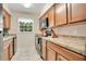 Clean and functional kitchen with wood cabinets and black appliances at 4944 Tangerine Ave # 4944, Winter Park, FL 32792