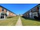 Brick apartment buildings with landscaping and a walkway at 5325 Curry Ford Rd # 101, Orlando, FL 32812