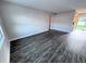 Spacious living room with wood-look floors at 5325 Curry Ford Rd # 101, Orlando, FL 32812