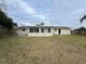 Back of house showing a large yard and updated exterior at 5822 Forest Grove Blvd, Orlando, FL 32808