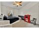 Cozy bedroom with a full-size bed and a red dresser at 5978 Braemar Pl # 108, Orlando, FL 32822