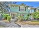 Front view of a charming two-story house with green siding at 5978 Braemar Pl # 108, Orlando, FL 32822