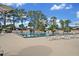 Community pool with lounge chairs and umbrellas at 5978 Braemar Pl # 108, Orlando, FL 32822