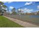 Community tennis courts with chain link fence at 5978 Braemar Pl # 108, Orlando, FL 32822