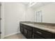 Bathroom with granite countertop and dark brown cabinets at 611 Marsh Reed Dr, Winter Garden, FL 34787