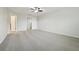 Carpeted bedroom with ceiling fan and access to bathroom at 611 Marsh Reed Dr, Winter Garden, FL 34787