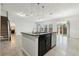 Modern kitchen island with granite countertop and stainless steel appliances at 611 Marsh Reed Dr, Winter Garden, FL 34787