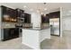 Modern kitchen with dark cabinets and stainless steel appliances at 611 Marsh Reed Dr, Winter Garden, FL 34787