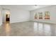 Bright living room with tile floors and large windows at 611 Marsh Reed Dr, Winter Garden, FL 34787