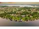 Aerial view showcases a community with waterfront homes, private docks, and lush landscaping offering a scenic and desirable lifestyle at 6564 Lagoon St, Windermere, FL 34786