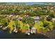 Stunning aerial view of a lakeside home with lush landscaping and private boat docks on a sunny day at 6564 Lagoon St, Windermere, FL 34786