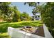 The backyard has a well maintained lawn, mature trees, a fire pit, and a patio with a pool, perfect for relaxation at 6564 Lagoon St, Windermere, FL 34786