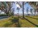 Landscaped backyard with lake access and dock at 6564 Lagoon St, Windermere, FL 34786