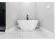 Modern freestanding bathtub with a black faucet at 6564 Lagoon St, Windermere, FL 34786