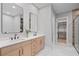 Modern bathroom with double vanity, sleek fixtures, and a walk-in closet for ample storage at 6564 Lagoon St, Windermere, FL 34786