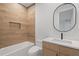 Beautiful bathroom featuring wood-look tile, soaking tub, and a modern vanity at 6564 Lagoon St, Windermere, FL 34786