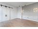 Modern bedroom with barn door and stylish wall sconces at 6564 Lagoon St, Windermere, FL 34786