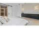 Serene bedroom featuring a barn door to the closet and modern lighting above a built-in console at 6564 Lagoon St, Windermere, FL 34786