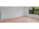 Minimalist bedroom with hardwood floors and a large window offering bright views at 6564 Lagoon St, Windermere, FL 34786