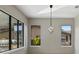 Light-filled dining room with large windows and modern chandelier at 6564 Lagoon St, Windermere, FL 34786