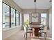 Elegant dining room featuring a wooden table, modern chandelier, and large windows for abundant natural light at 6564 Lagoon St, Windermere, FL 34786