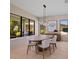 Dining room with hardwood floors, modern lighting fixture, large windows with a view of the backyard at 6564 Lagoon St, Windermere, FL 34786