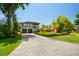 Spacious front yard featuring a lush lawn and a charming two-story home with two-car garage at 6564 Lagoon St, Windermere, FL 34786