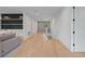 Bright hallway featuring sleek hardwood flooring, access to staircase, and wet bar at 6564 Lagoon St, Windermere, FL 34786