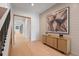 Bright hallway with light wood floors, modern art, and an open doorway at 6564 Lagoon St, Windermere, FL 34786
