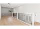 Modern hallway with light oak hardwood floors and metal railing at 6564 Lagoon St, Windermere, FL 34786