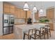 Modern kitchen with marble island, stainless steel refrigerator, and ample cabinet space at 6564 Lagoon St, Windermere, FL 34786
