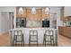 Bright, modern kitchen featuring stainless steel appliances, a marble island with seating, and stylish pendant lighting at 6564 Lagoon St, Windermere, FL 34786