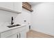 Bright laundry room with white cabinets and a stylish sink at 6564 Lagoon St, Windermere, FL 34786