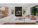 Open-concept living area featuring a fireplace, modern decor, and seamless flow to the kitchen with barstool seating at 6564 Lagoon St, Windermere, FL 34786