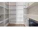 Modern white pantry with ample shelving and wine cooler at 6564 Lagoon St, Windermere, FL 34786