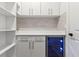 White pantry with built-in shelving and wine cooler at 6564 Lagoon St, Windermere, FL 34786