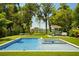 Sparkling pool and spa surrounded by lush landscaping and mature trees offering a private and relaxing outdoor oasis at 6564 Lagoon St, Windermere, FL 34786