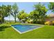 Sparkling pool and spa surrounded by lush landscaping and mature trees offering a private and relaxing outdoor oasis at 6564 Lagoon St, Windermere, FL 34786