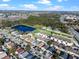 Aerial view of townhouses with pool, near lake and other homes at 7415 Lago De Oro # 2, Orlando, FL 32822