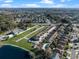 Aerial view of townhouses with pool, near lake and other homes at 7415 Lago De Oro # 2, Orlando, FL 32822