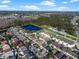 Aerial view of townhouses with pool, near lake and other homes at 7415 Lago De Oro # 2, Orlando, FL 32822