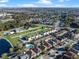 Aerial view of townhouses with pool, near lake and other homes at 7415 Lago De Oro # 2, Orlando, FL 32822