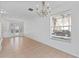 Bright dining room with chandelier and view of the front door at 7415 Lago De Oro # 2, Orlando, FL 32822