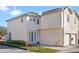 Two-story townhome with white door and attached garage, in a residential area at 7415 Lago De Oro # 2, Orlando, FL 32822