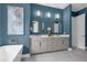 Bathroom features dual sinks, modern lighting, and a large painting, creating a stylish and functional space at 809 Maxwell St, Orlando, FL 32804