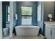 Contemporary bathroom boasts a freestanding tub, modern fixtures, and large windows for natural light at 809 Maxwell St, Orlando, FL 32804